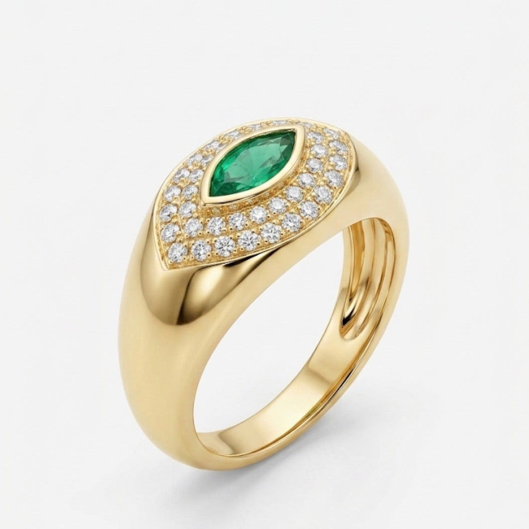 Gold ring with a green gemstone and diamond accents on a white background